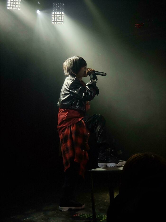 Singer in dramatic lighting on stage, evoking an accidental Renaissance painting style.