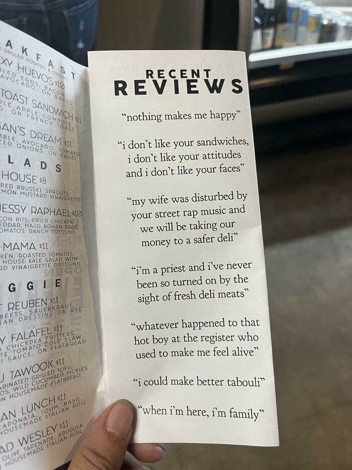 Funny reviews displayed on a deli menu, highlighting humorous customer feedback.