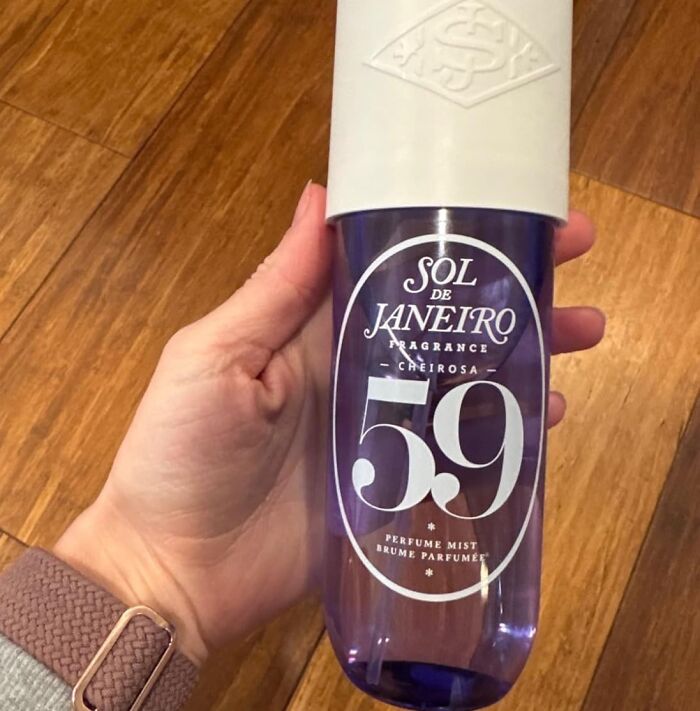 Hand holding Sol de Janeiro fragrance mist, perfect for showoffs.