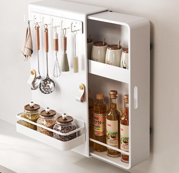 Organized kitchen rack with utensils, spice jars, and bottles for a reinvented fridge and pantry setup.