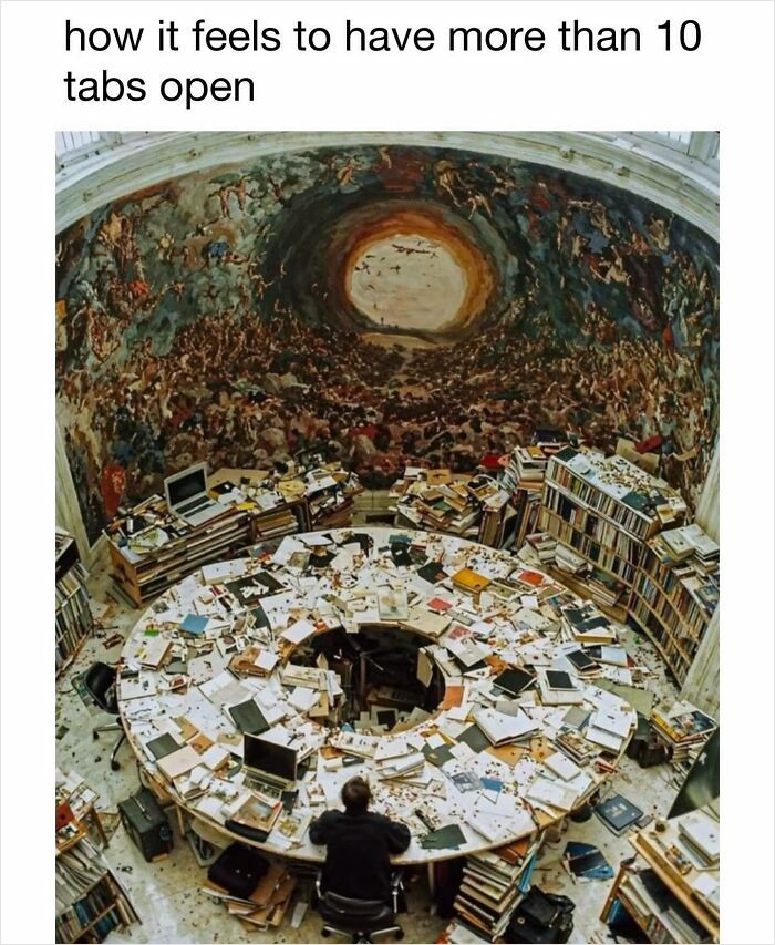 Person overwhelmed at a cluttered desk, illustrating a funny meme about having many browser tabs open.