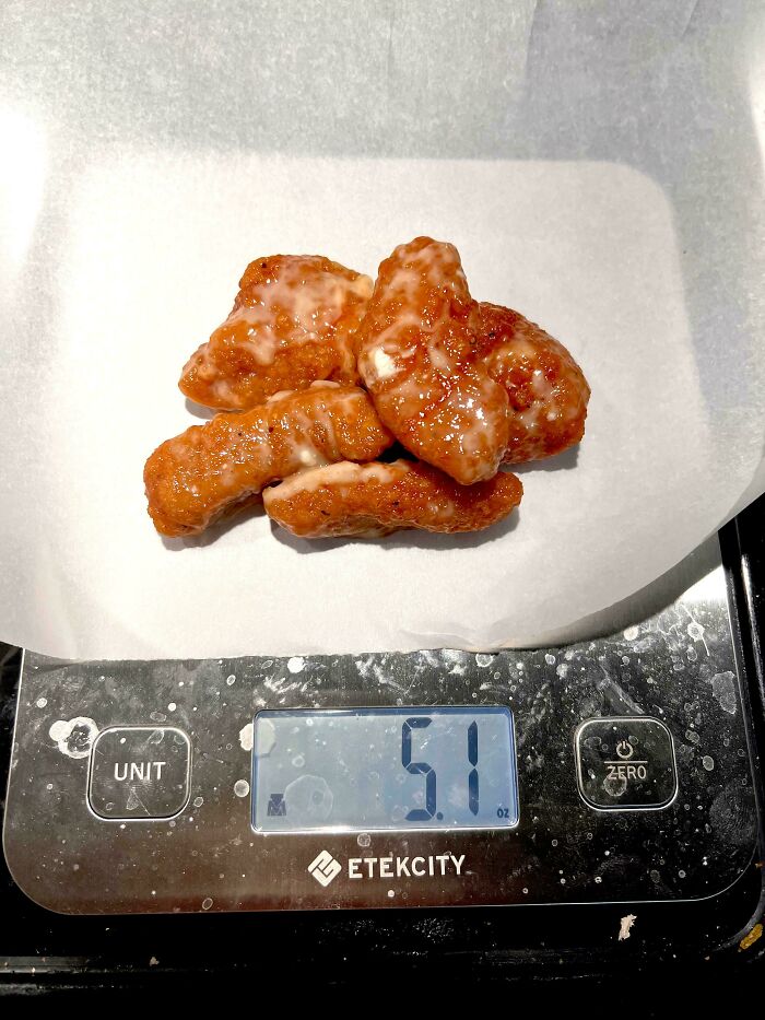 Chicken nuggets on a digital scale showing 5.1 ounces, illustrating food scams with misleading packaging or portion sizes.