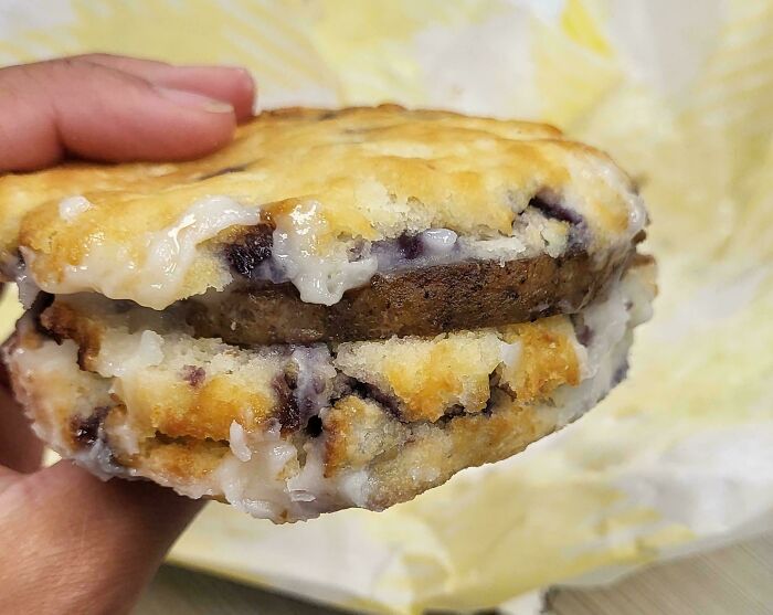 Close-up of a blueberry muffin sliced in half with sausage inside, highlighting food scams.