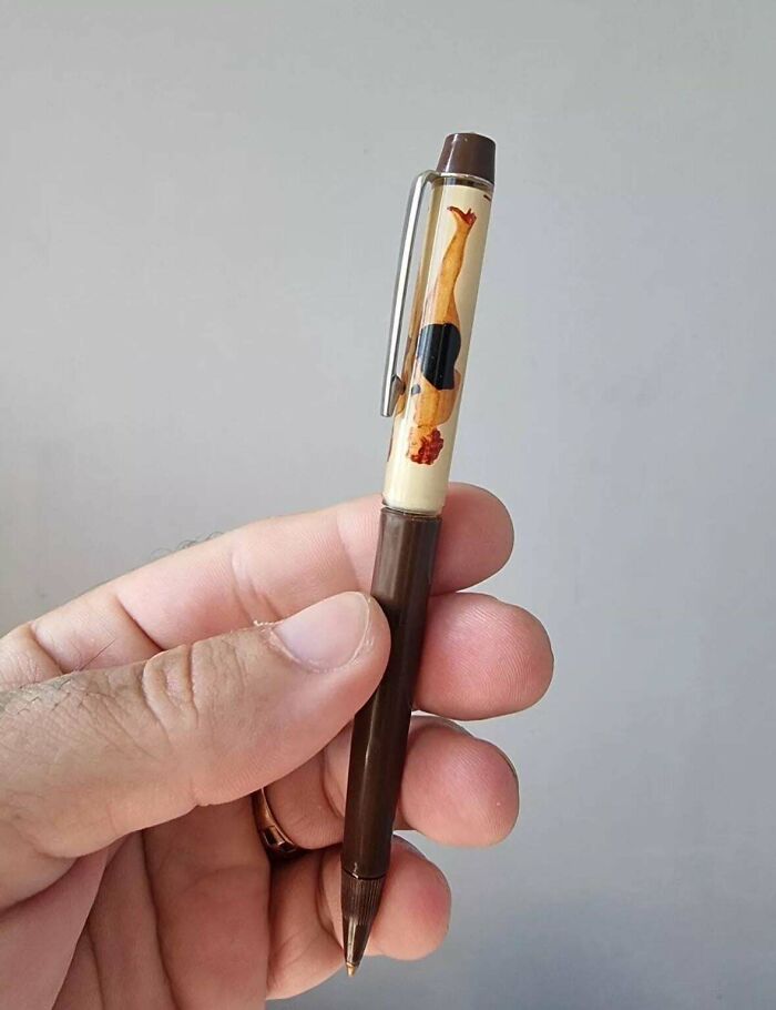 Retro nostalgic pen with a miniature diver inside, held in hand as a collectible vintage item from past decades.