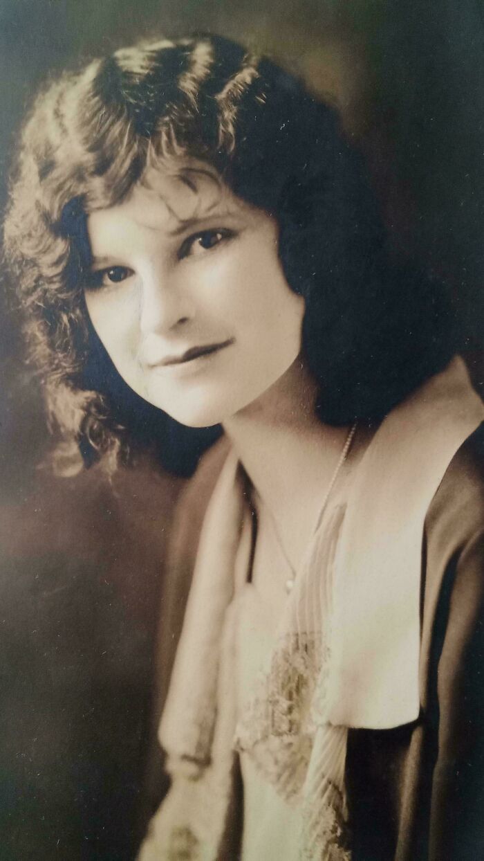 Vintage portrait of a woman with curly hair, showcasing fascinating old images from history not seen in class.