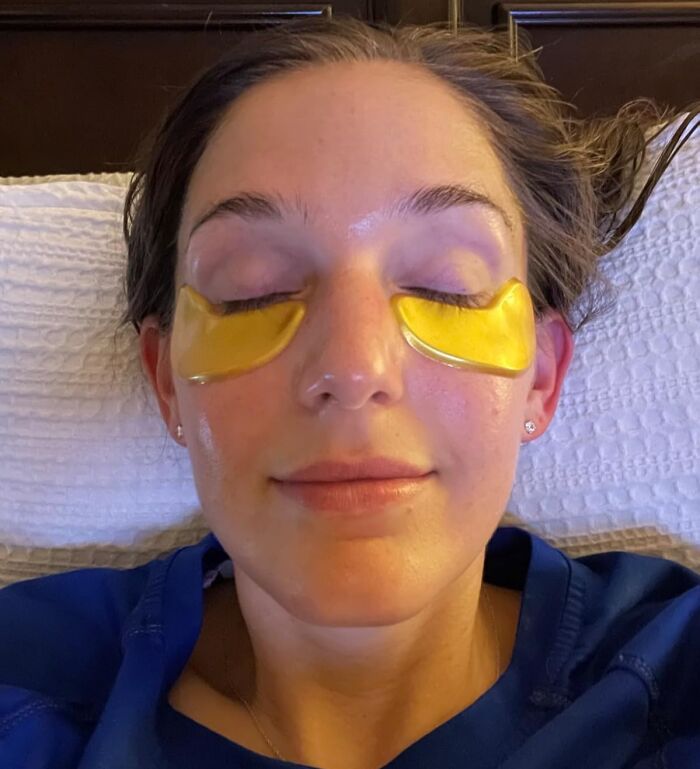 Woman relaxing with gold under-eye patches, perfect for best Valentines Day finds.