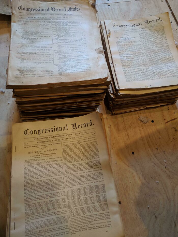 Stacks of vintage Congressional Record pages on a wooden table, representing cool old things.