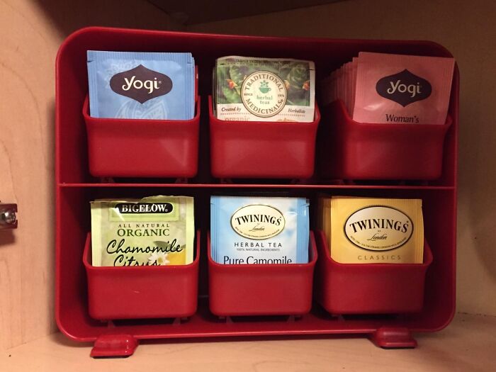 Tea bag organizer with six red compartments for a small kitchen.