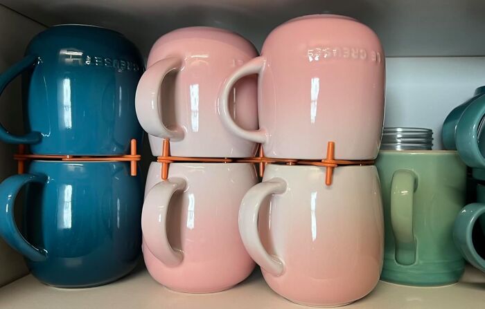 Stacked mugs with space-saving design in a small kitchen setting.