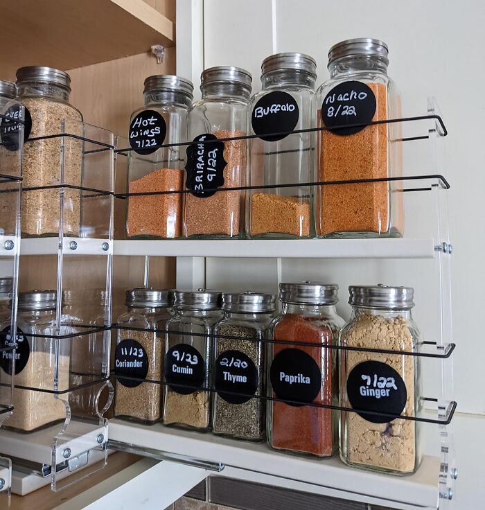 Spice jars organized on a rack in a small kitchen, highlighting efficient design products.