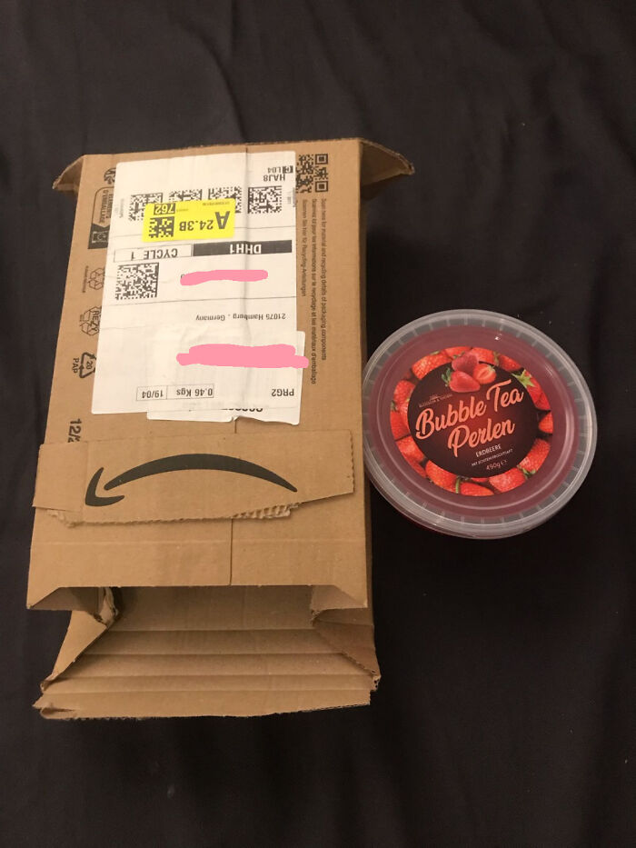 Unexpected online shopping package with large box and small bubble tea container.