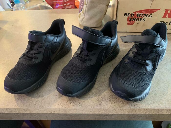 Three mismatched black shoes, illustrating online shopping fails.