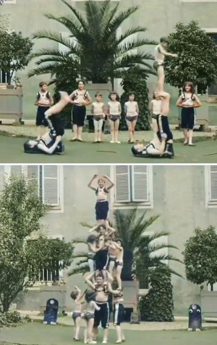 Children performing acrobatics in vintage athletic attire, forming human pyramids in a historical setting with palm trees.