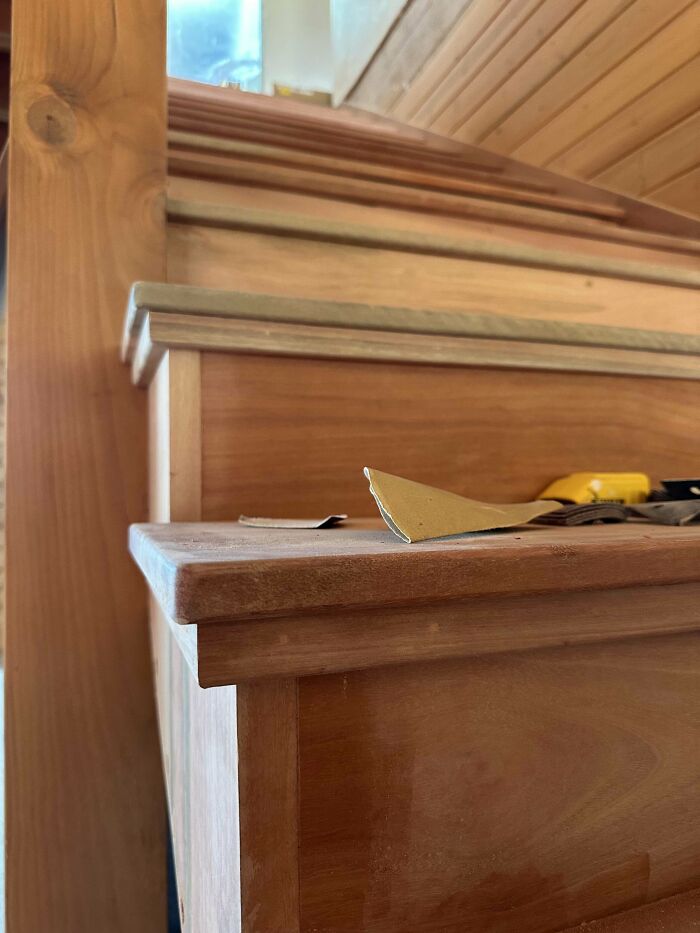 Woodworking projects showcasing detailed wooden staircase construction with tools on the step.