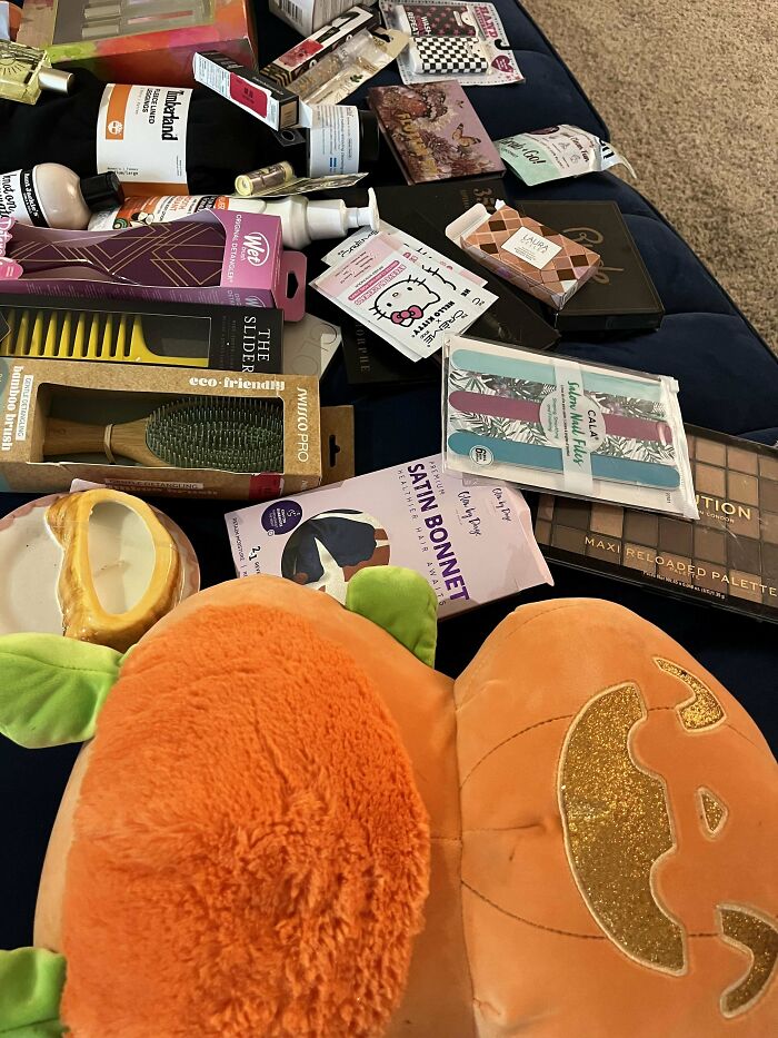 Assorted items and beauty products found dumpster diving, showcasing valuable finds with a $550 price tag.
