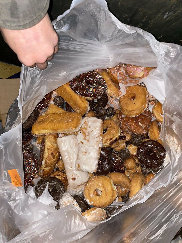 A bag filled with assorted pastries and donuts found during dumpster diving.