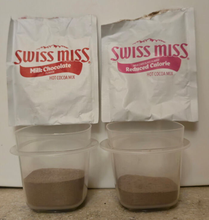 Swiss Miss hot cocoa mix comparison with milk chocolate and reduced calorie packets above plastic containers of powder.