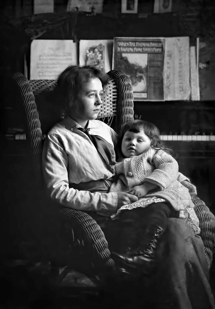 Victorian era mother and child seated, with piano sheet music in the background.