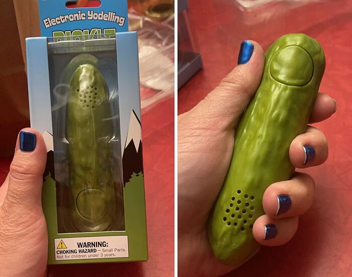 Electronic yodeling pickle in packaging and being held, showcasing one of the funniest Amazon finds.