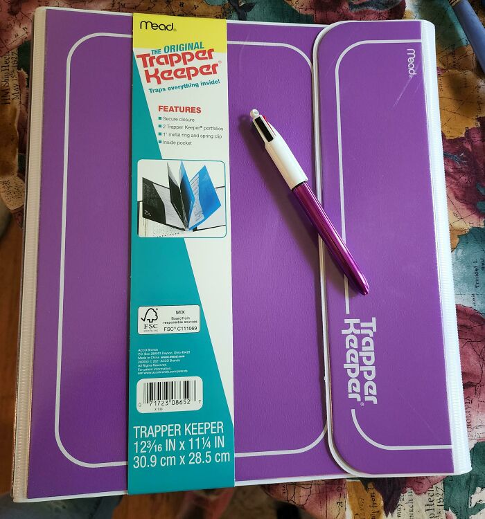Purple Trapper Keeper and pen evoke memories of old-school items.