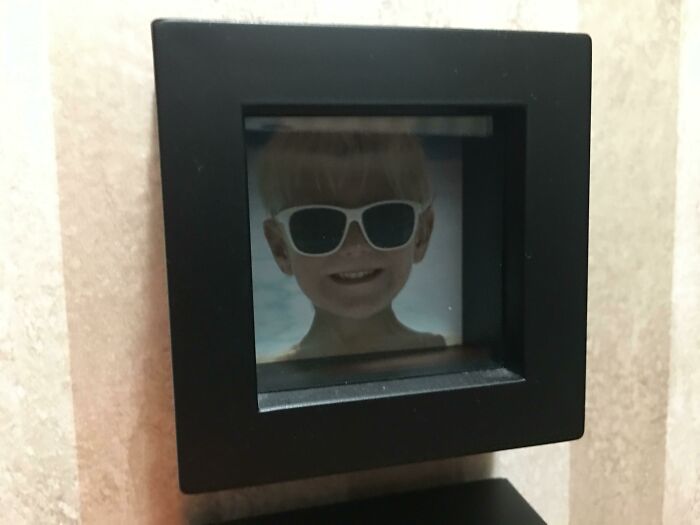Child with sunglasses in a small square frame, highlighting hilarious misunderstandings from a creative angle.