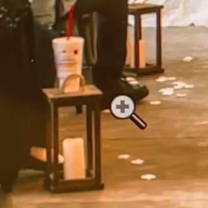 A drink cup on a lantern at a wedding, suggesting the presence of terrible guests.