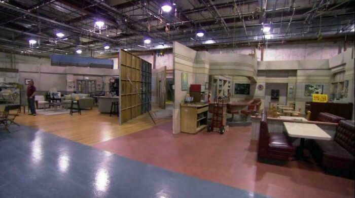 Film set interior showing behind-the-scenes perspective of a famous sitcom's living room and dining area.