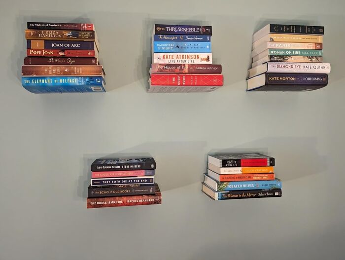 Floating bookshelves displaying assorted books as a simple DIY project for not-handy people.