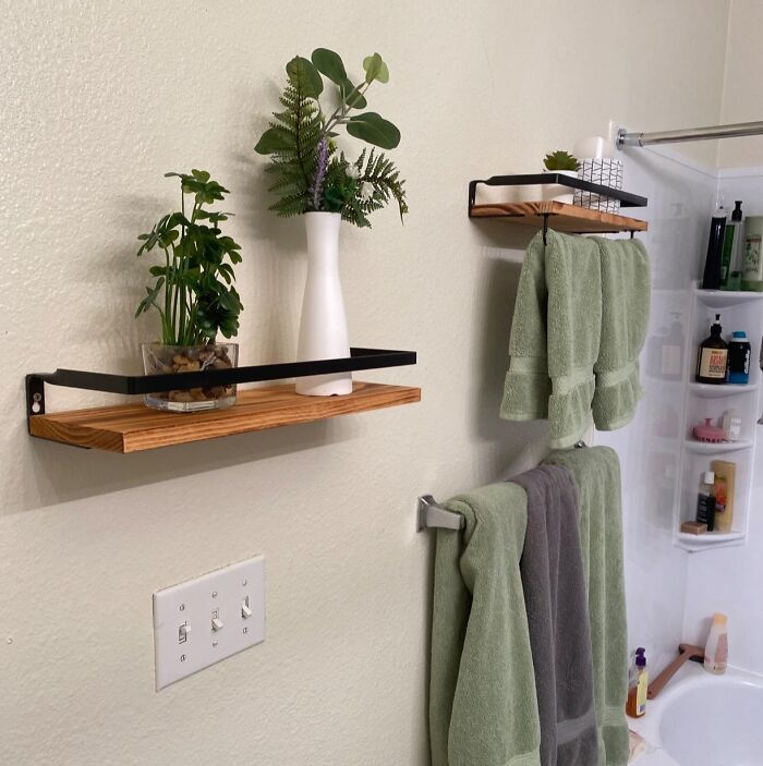 DIY bathroom shelves with plants and green towels, easy for not-handy people.