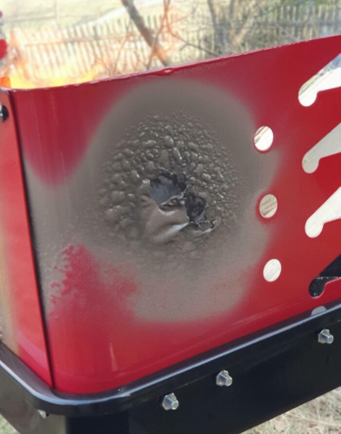 Damaged red surface on a low-quality item bought by someone.