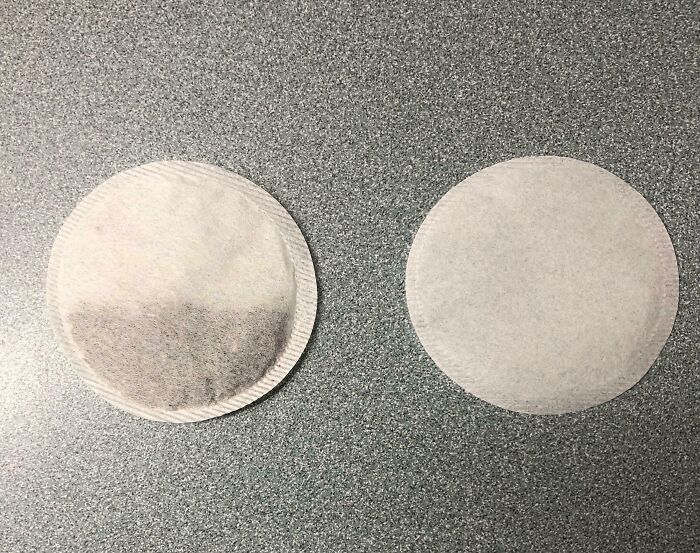 Low-quality item: two tea bags, one appears empty, highlighting poor tea quality on a gray surface.