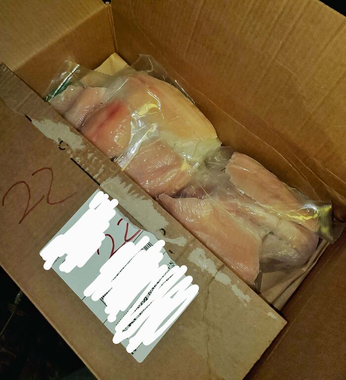 Cardboard box containing low-quality packaged meat items.