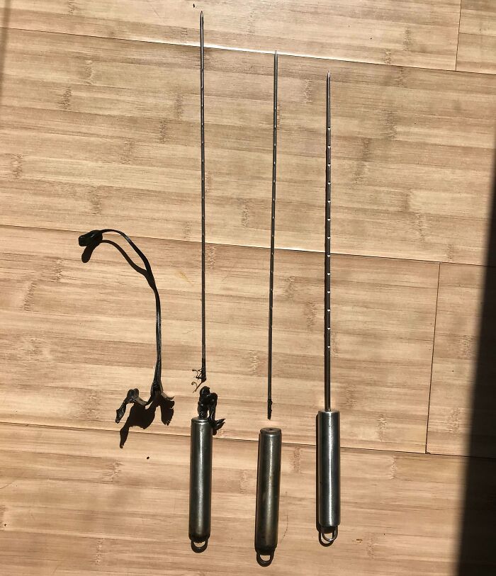 Low-quality skewers with broken handles displayed on a wooden surface, highlighting flawed design.