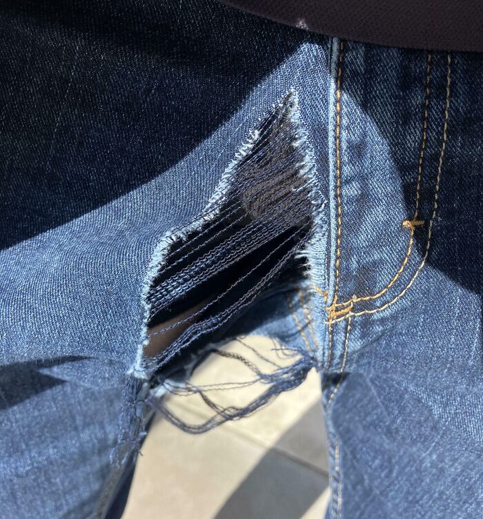 Ripped jeans with torn fabric, representing low-quality items.