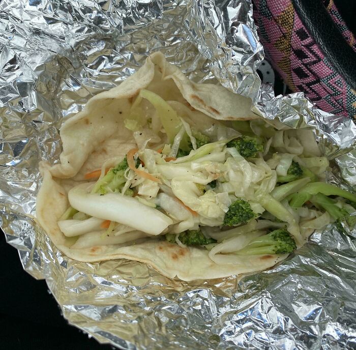 Veggie wrap in foil with sparse filling, highlighting food scams.