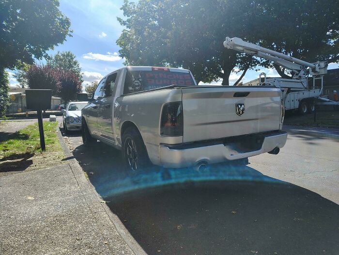 Pickup truck parked on sidewalk, creating inconvenience, reflecting issues with terrible neighbors.