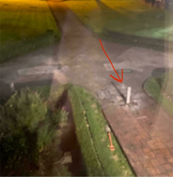 A red arrow pointing at a pole on a walkway, symbolizing infuriating terrible neighbors.