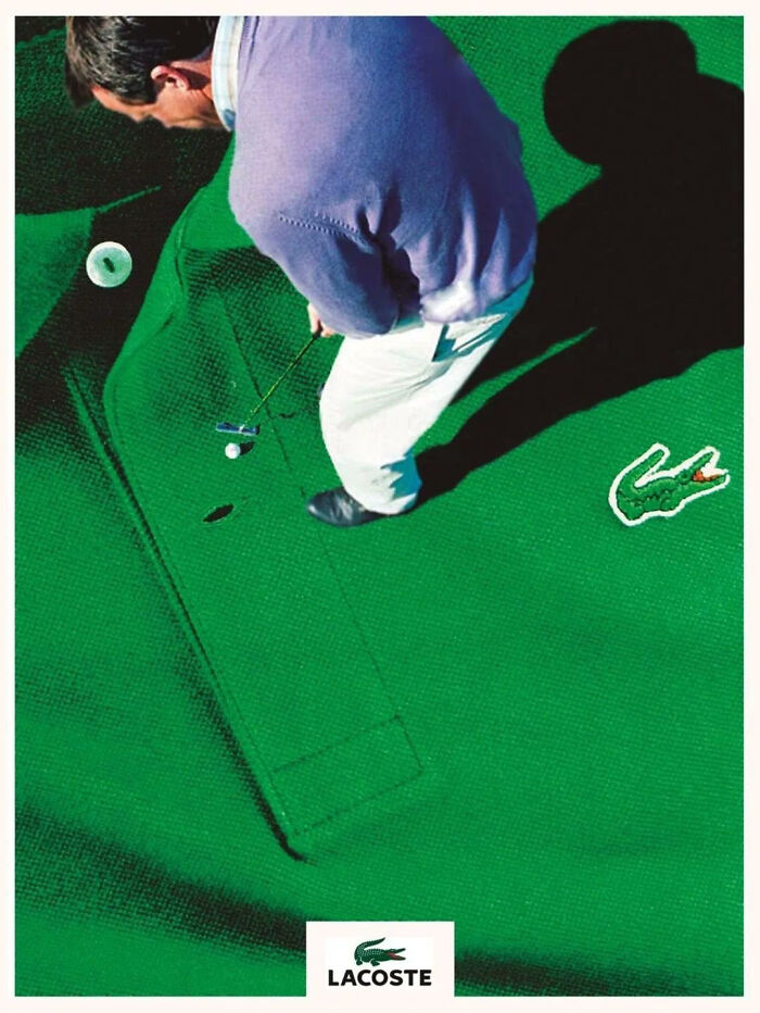 Man playing mini golf on a green shirt designed with a Lacoste logo, showcasing clever designer creativity and innovation.