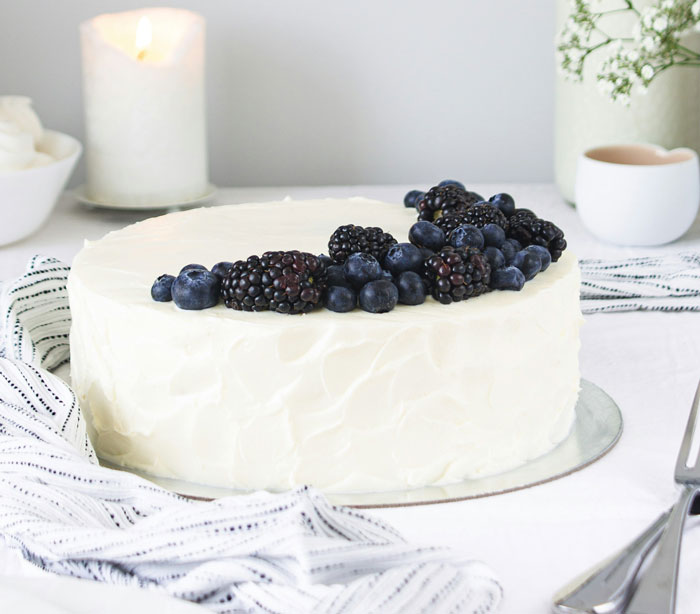 Cake with white frosting and berries on top, placed on a striped cloth, symbolizing a sobriety milestone celebration. Cake with white frosting and berries on top, placed on a striped cloth, symbolizing a sobriety milestone celebration.