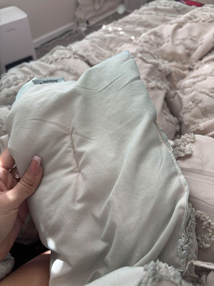 Woman holding a white blanket with visible stains, discussed in online user jokes about a mistress.