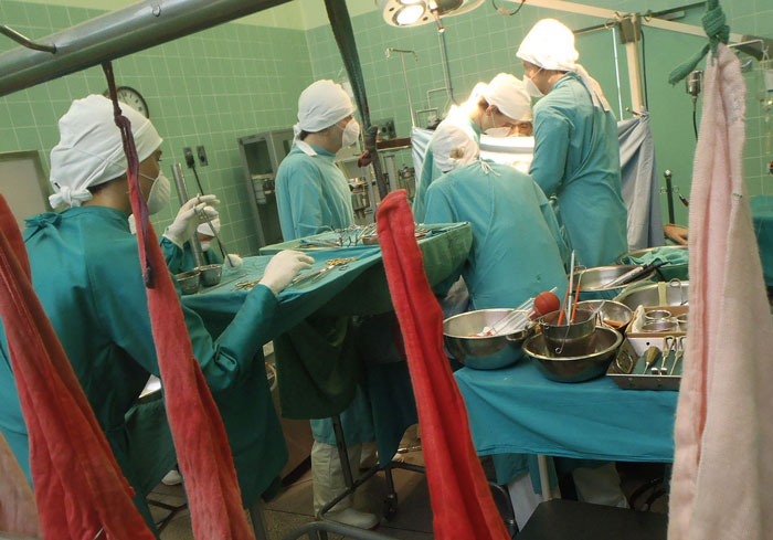 Medical team performing surgery, showcasing the sacrifice and dedication in a sterile operating room environment.
