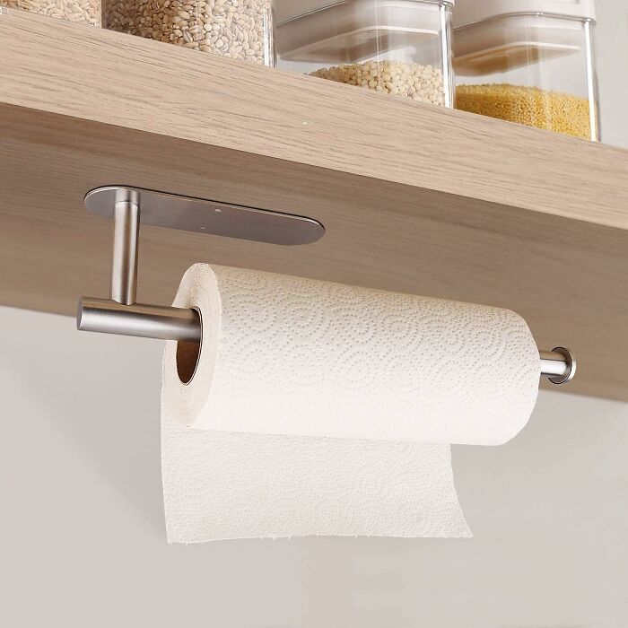 Under-shelf paper towel holder installed in a small kitchen, showcasing clever small kitchen solutions for cluttered spaces.