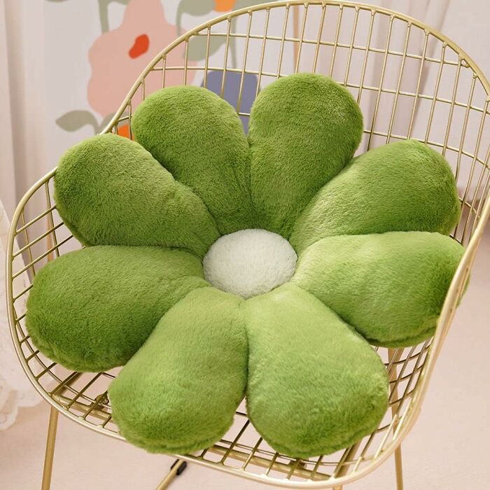 Green flower-shaped plush pillow on a gold wire chair, showcasing retro finds for the old soul who loves vintage style.