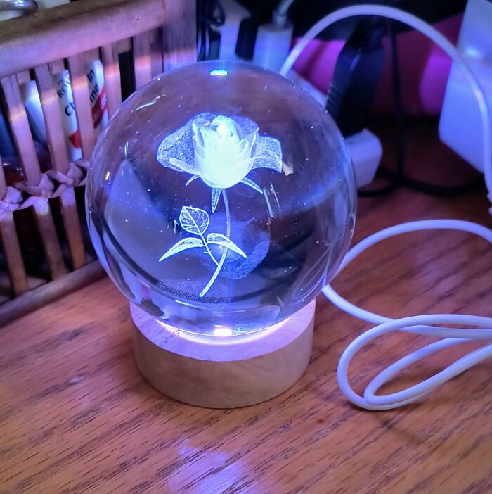 Crystal orb with an illuminated 3D rose inside, perfect for those who love cool products and showing off unique decor.