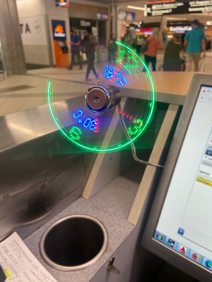 Digital display fan showing time and temperature, blending technology with a futuristic feel in a modern setting.