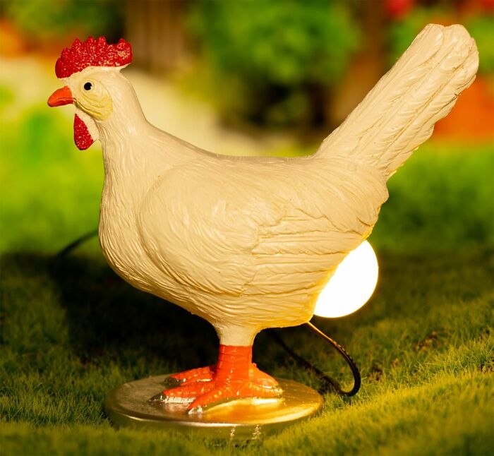 Chicken-shaped lamp illuminating a garden, showcasing Dopamine Decor style.