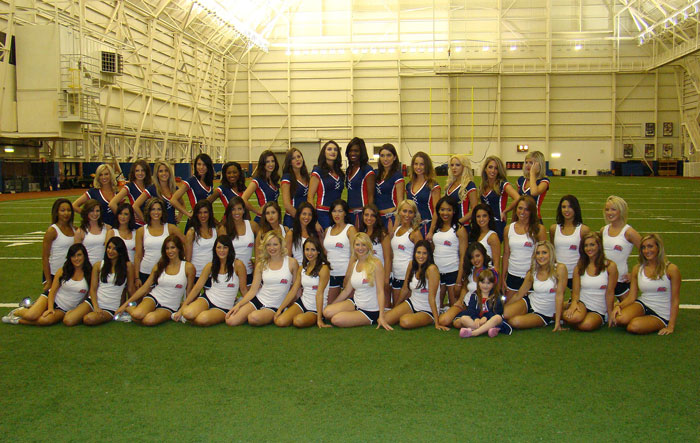 Buffalo Bills cheerleaders group photo taken inside a large indoor sports facility. Buffalo Bills cheerleaders group photo taken inside a large indoor sports facility.