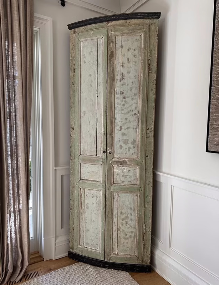 Vintage wooden wardrobe for sale, reflecting luxury influencer's need to sell belongings after debt crisis.