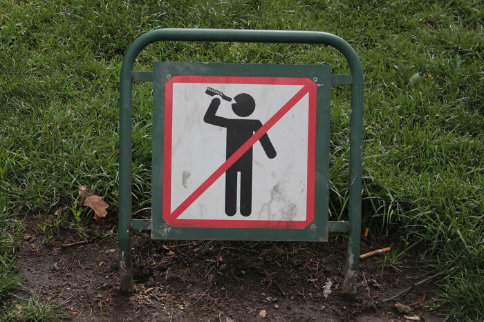 "Prohibition sign on grassy area, representing overlooked historical events related to public behavior regulations."
