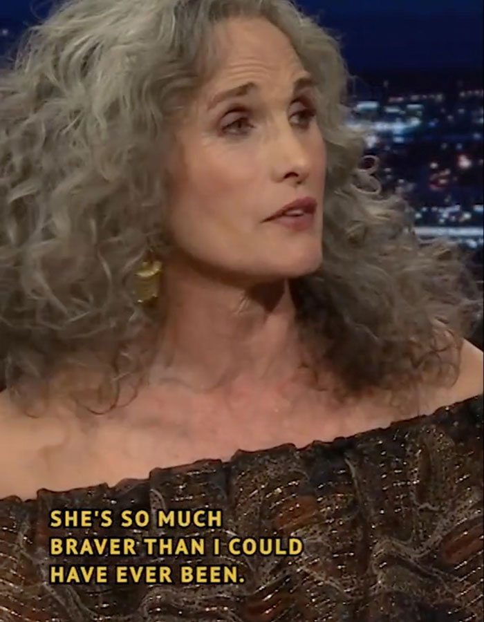 Mature woman with curly gray hair in a TV interview; text overlay about bravery. Related to "reverse nepotism" discussion.